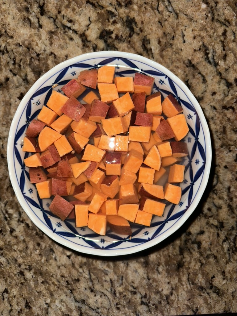 sweet potatoes diced submerged in water